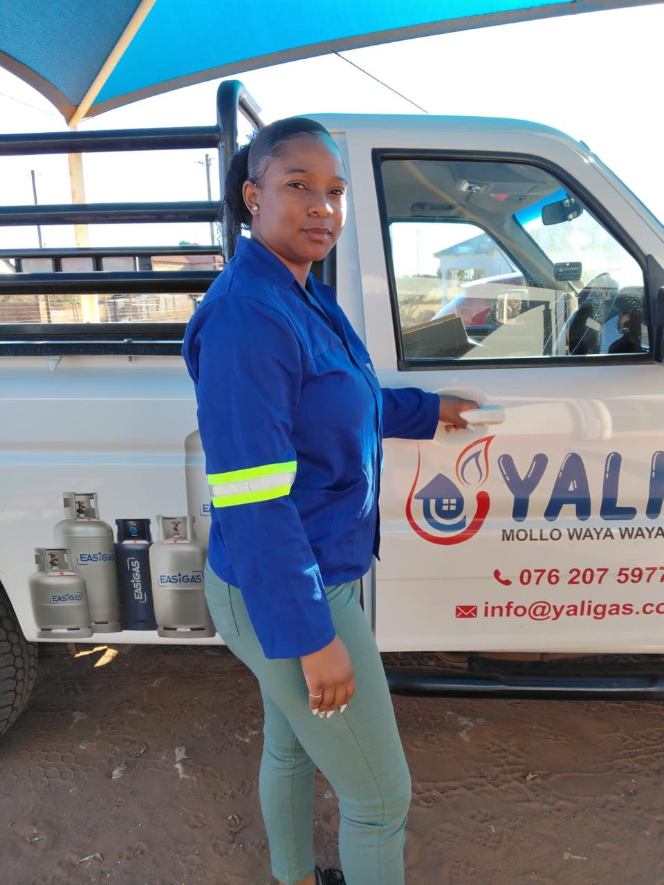 Yali Gas representative beside branded vehicle